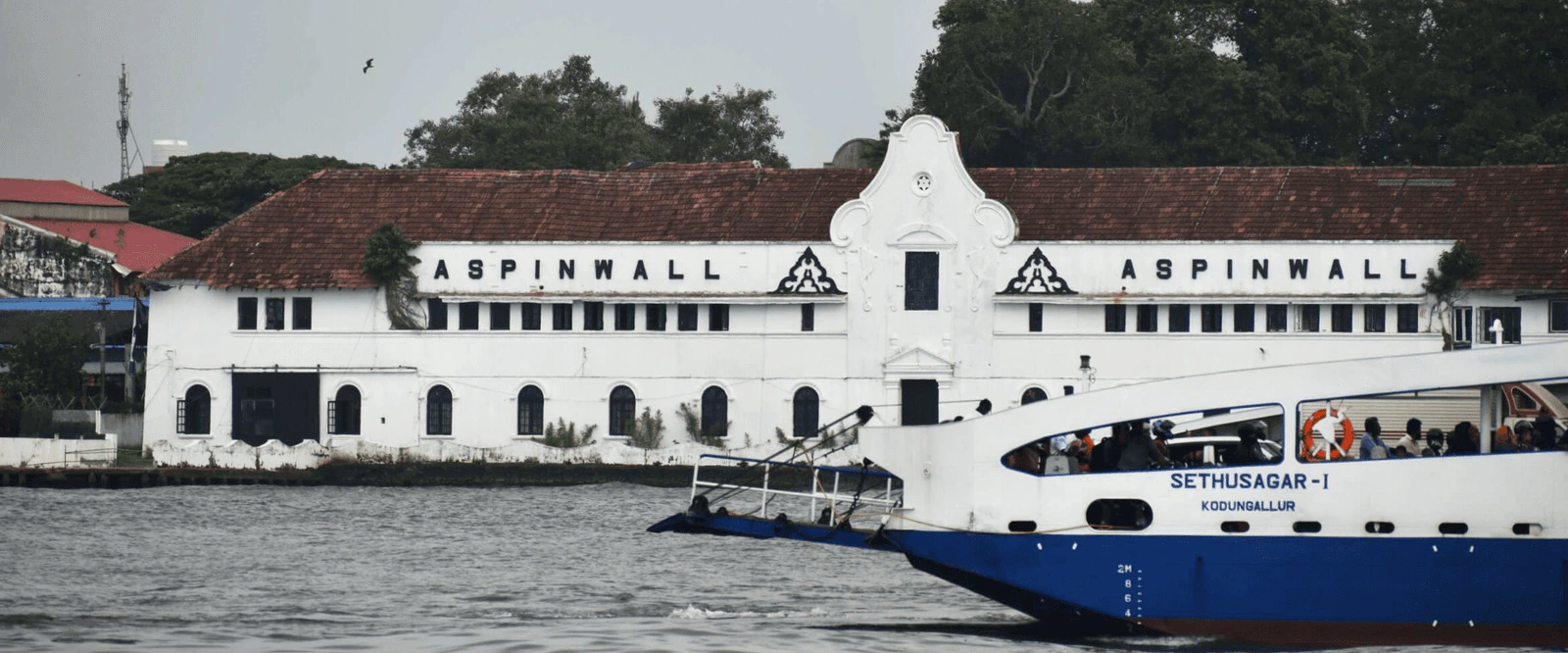 Heritage building and ferry on the Kochi backwaters