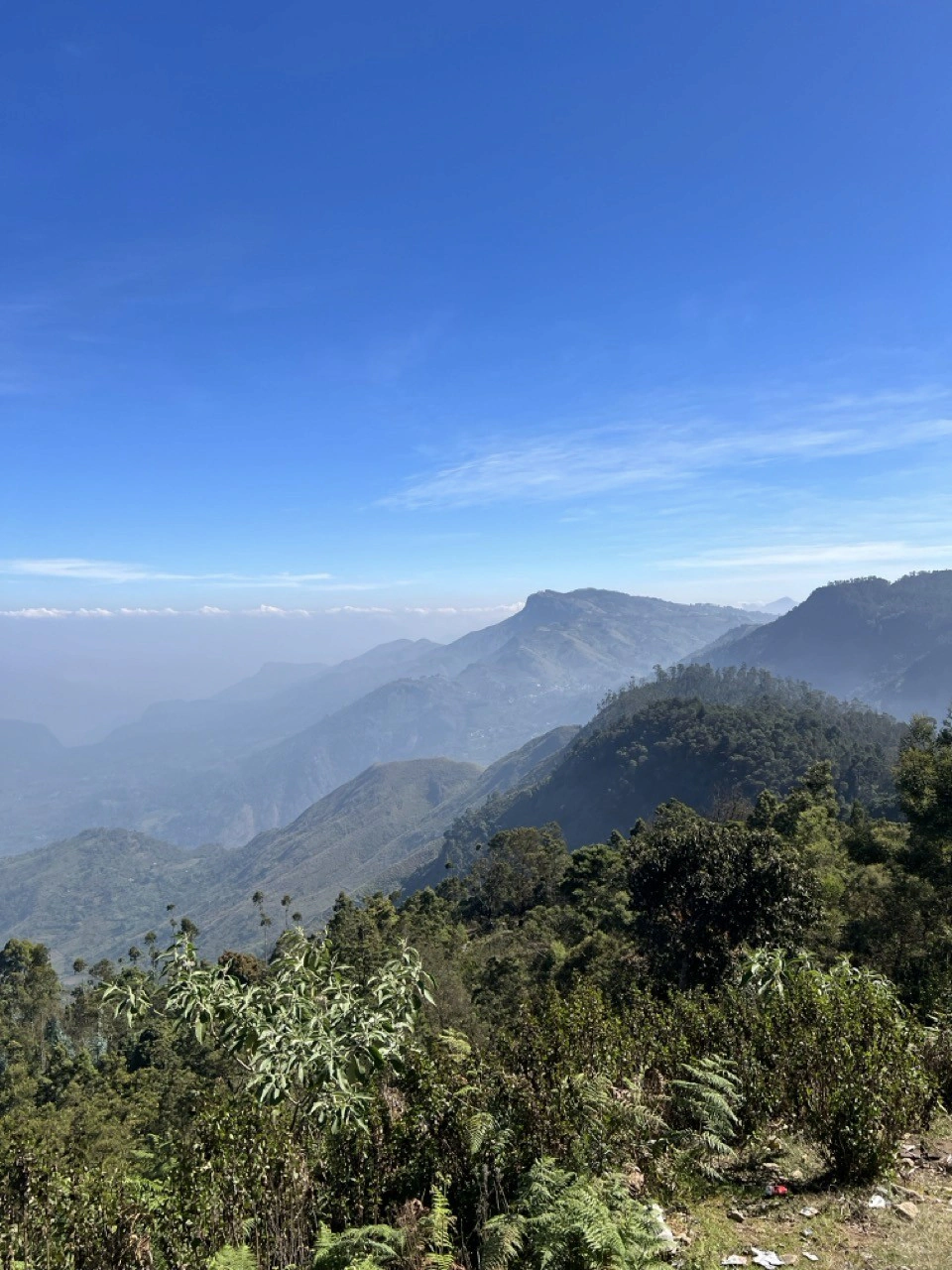 Misty mountain range under a blue sky